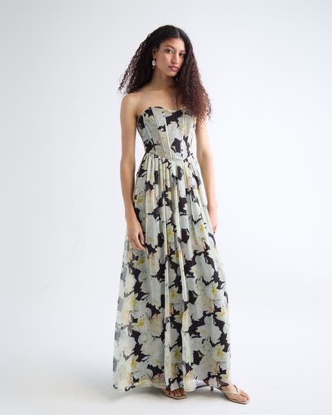 Woman wearing a floral gown and thong heels.
