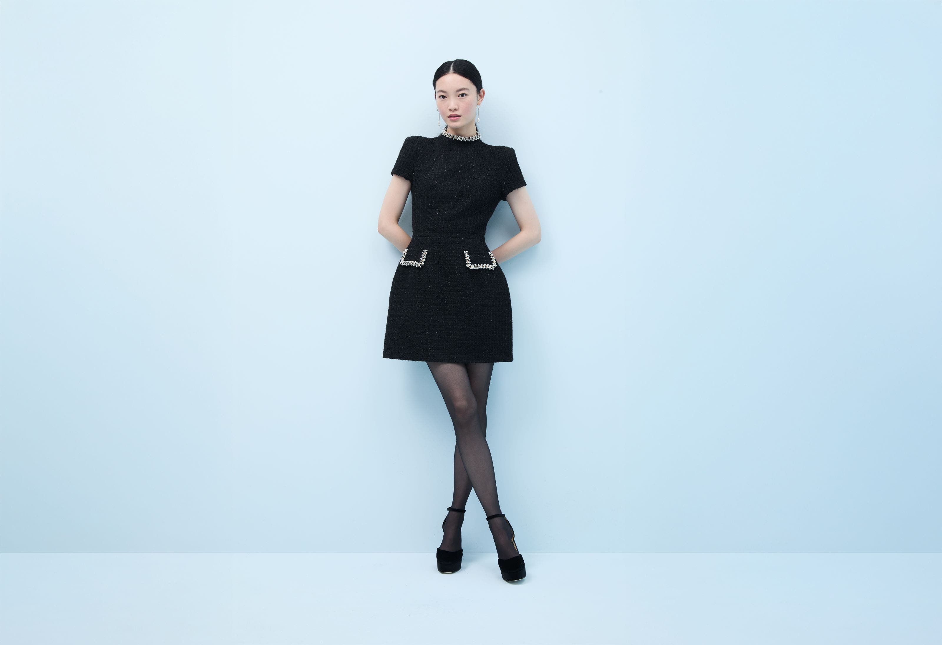 Woman wearing a little black dress with embellishment.