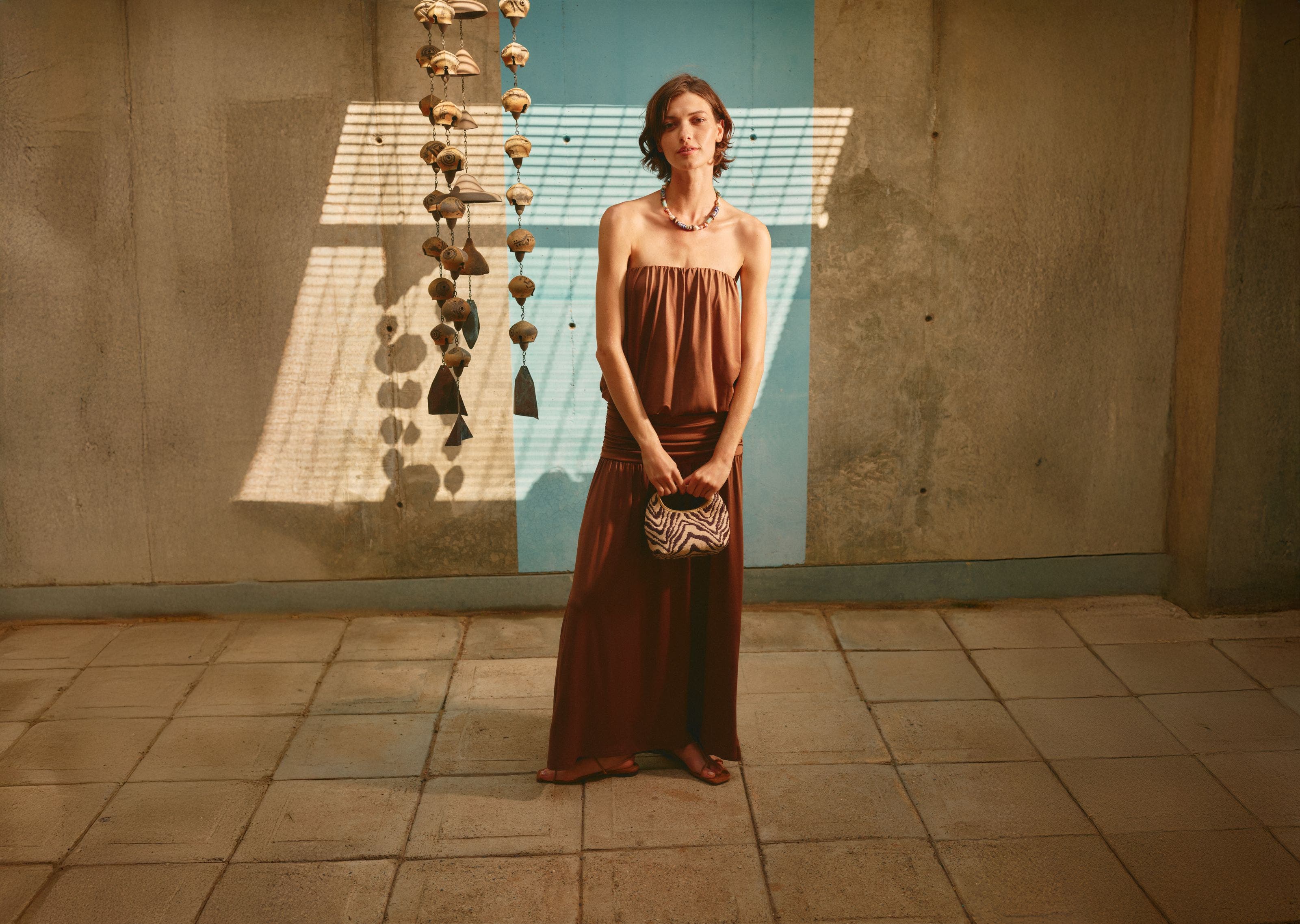 Woman wearing a strapless maxi dress.