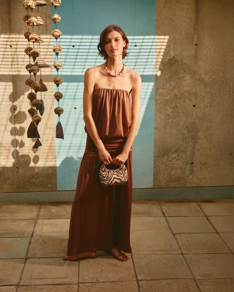 Woman wearing a strapless maxi dress.