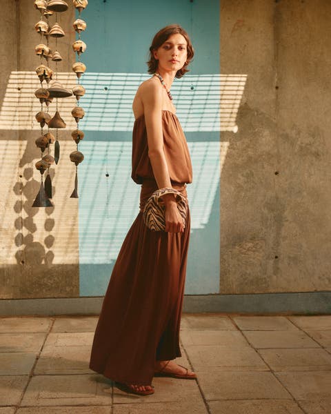 Woman wearing a strapless maxi dress.