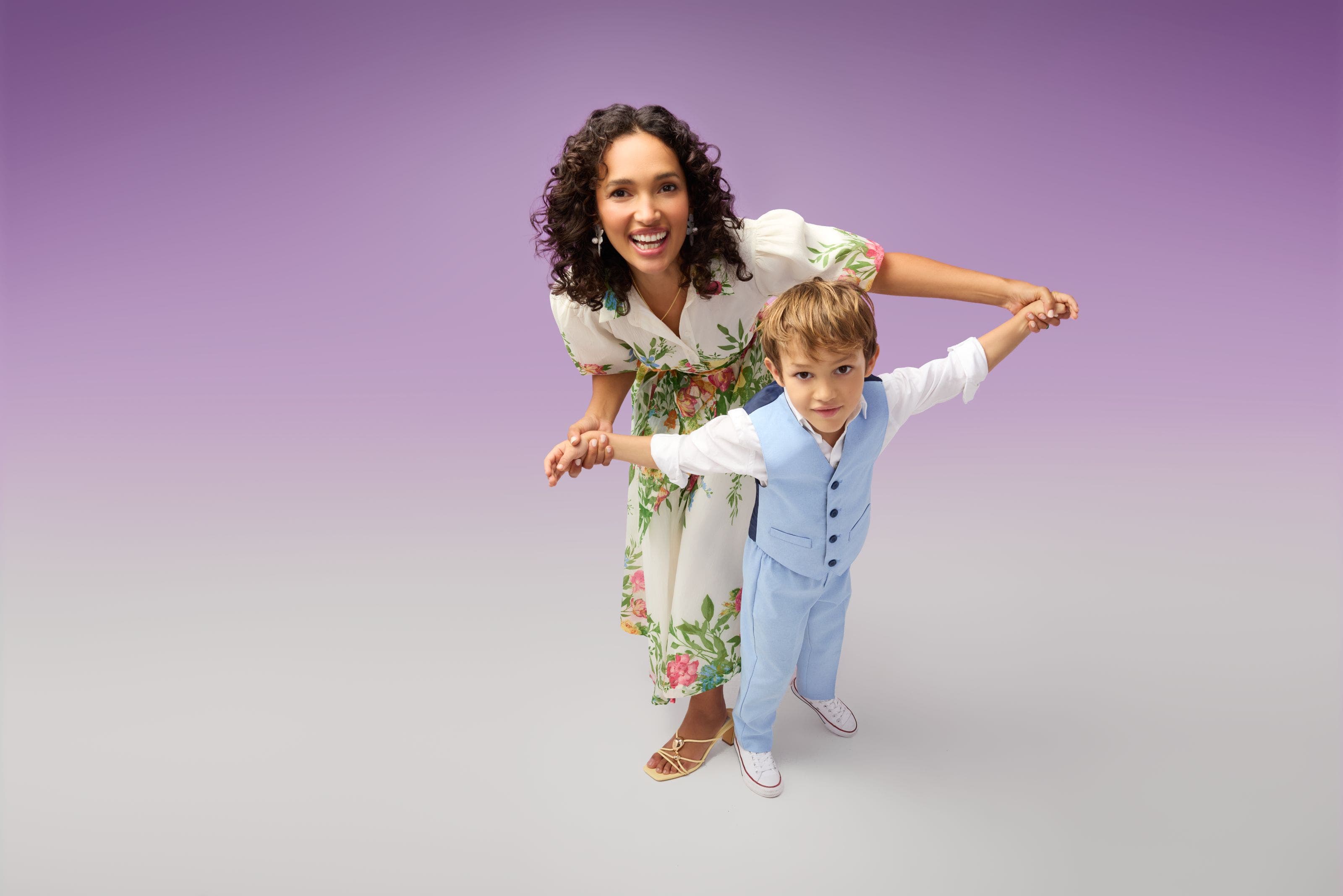 A woman and young boy in dressy spring outfits. 