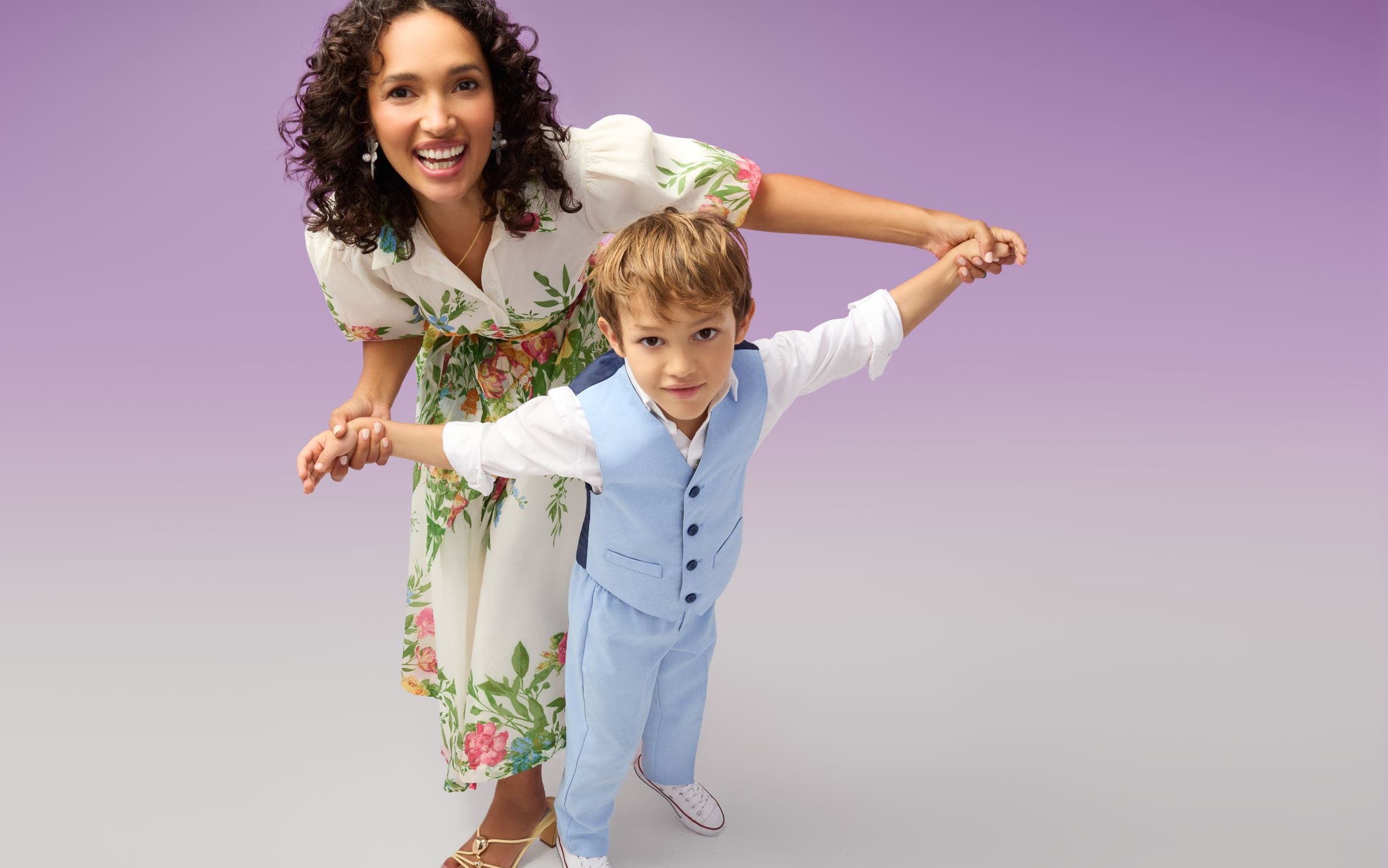 A woman and young boy in dressy spring outfits.
