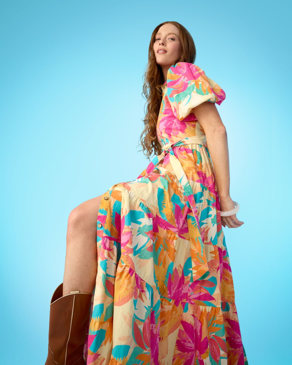 A woman wearing a floral puff-sleeve dress.
