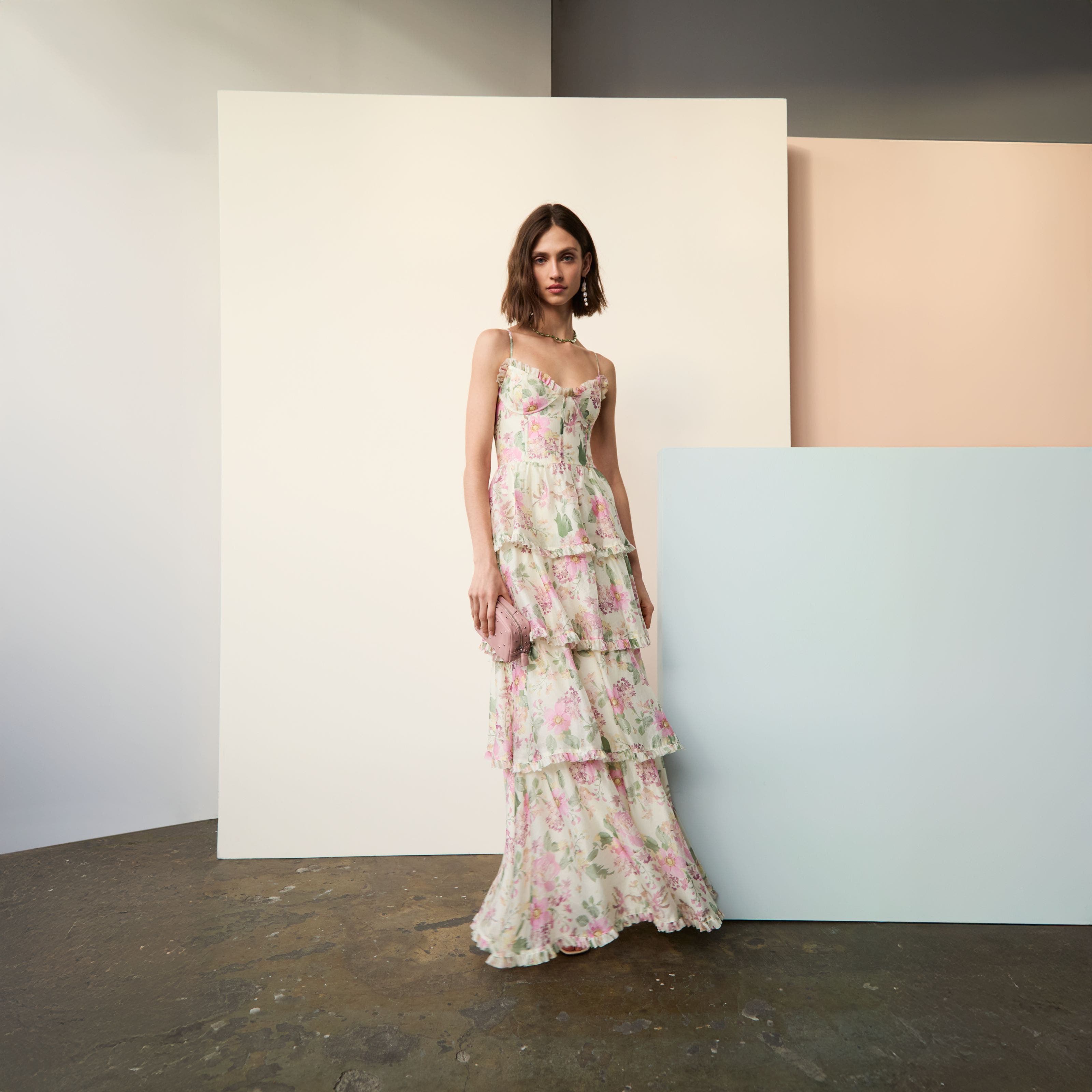 A woman wearing tiered floral maxi dress. 