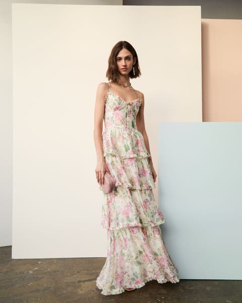 A woman wearing tiered floral maxi dress. 