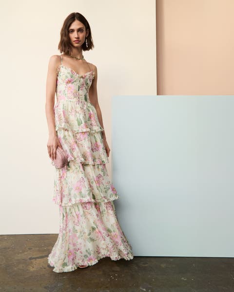 A woman wearing tiered floral maxi dress.