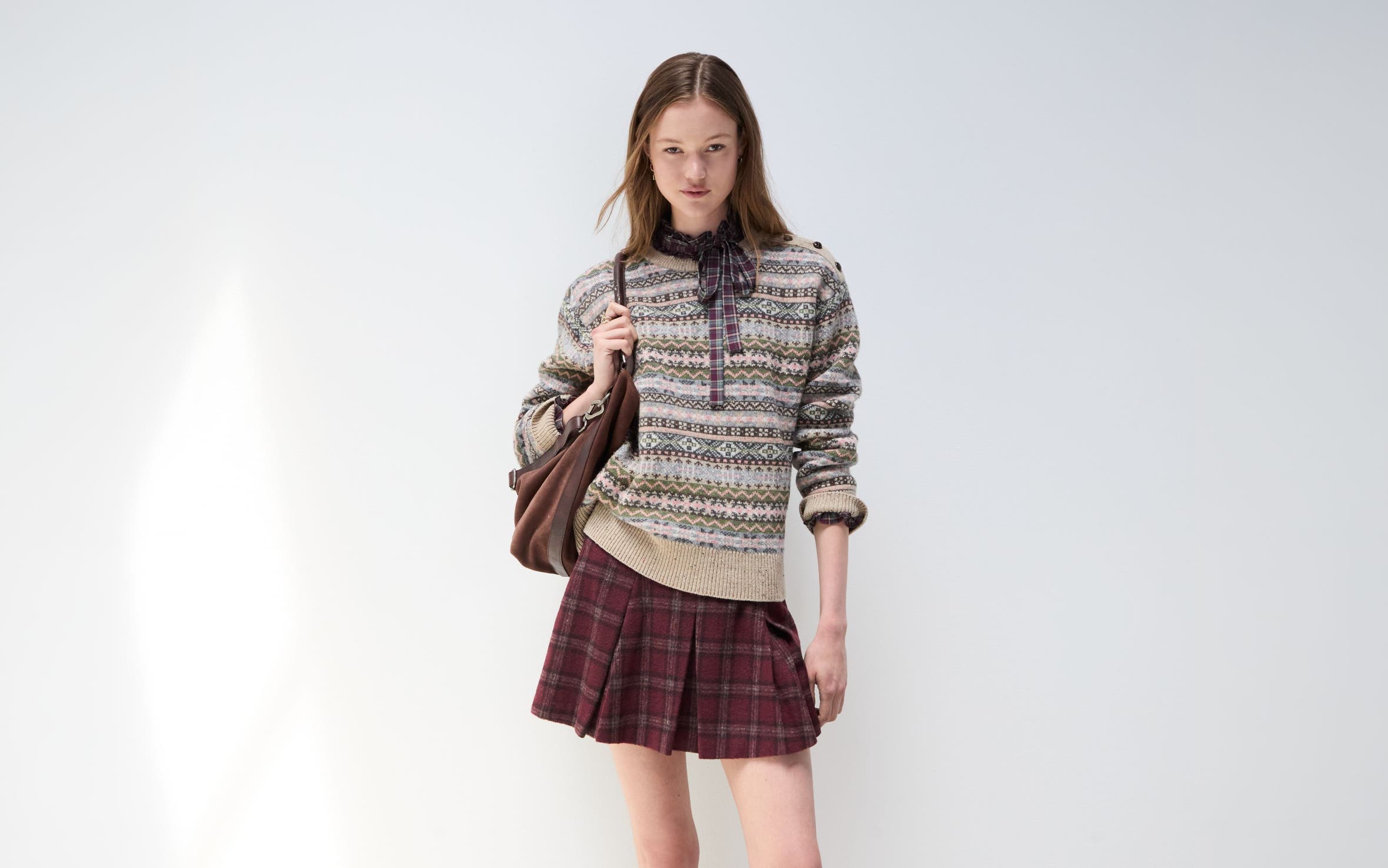 A woman in a cozy sweater and skirt.