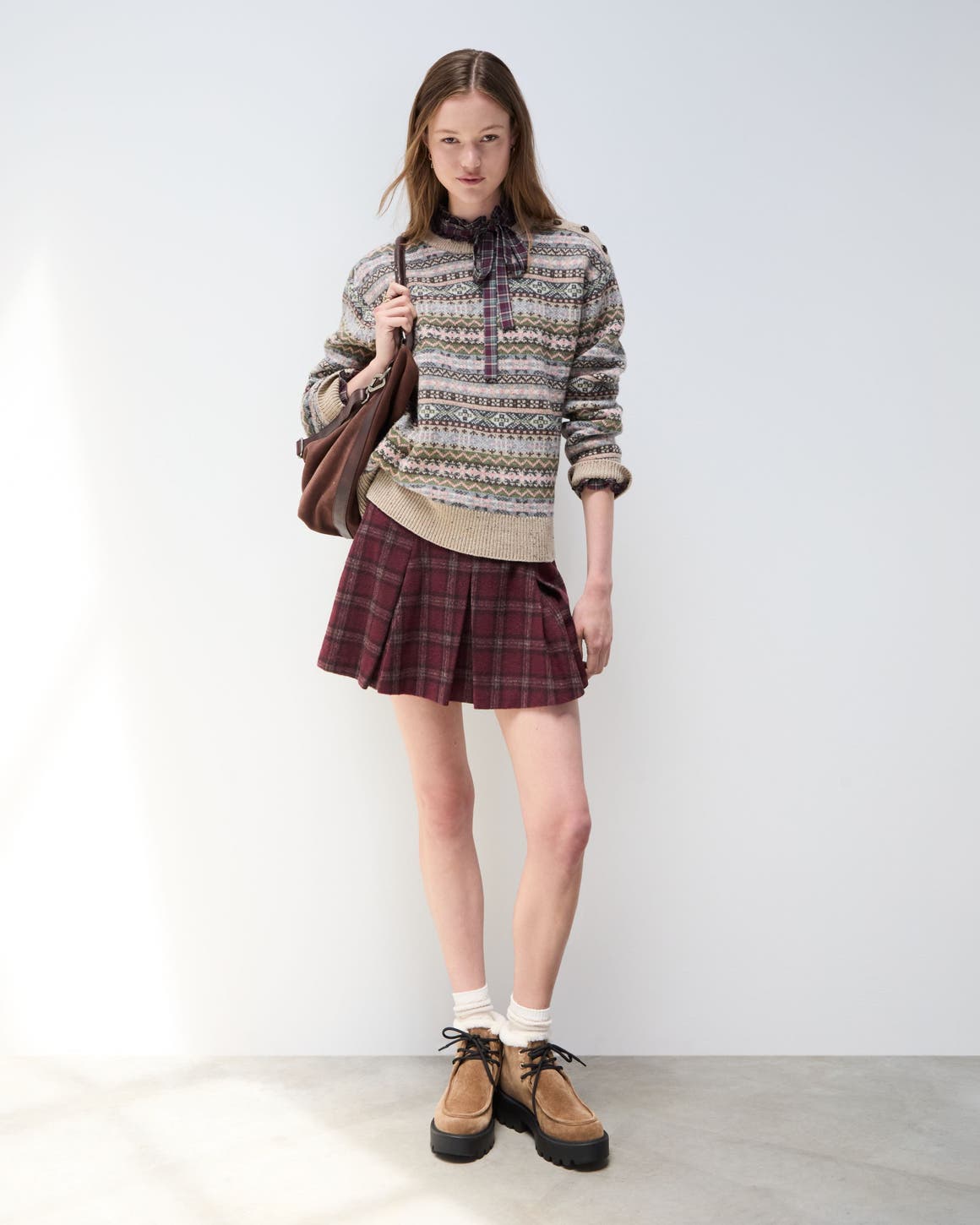 A woman in a cozy sweater and skirt.