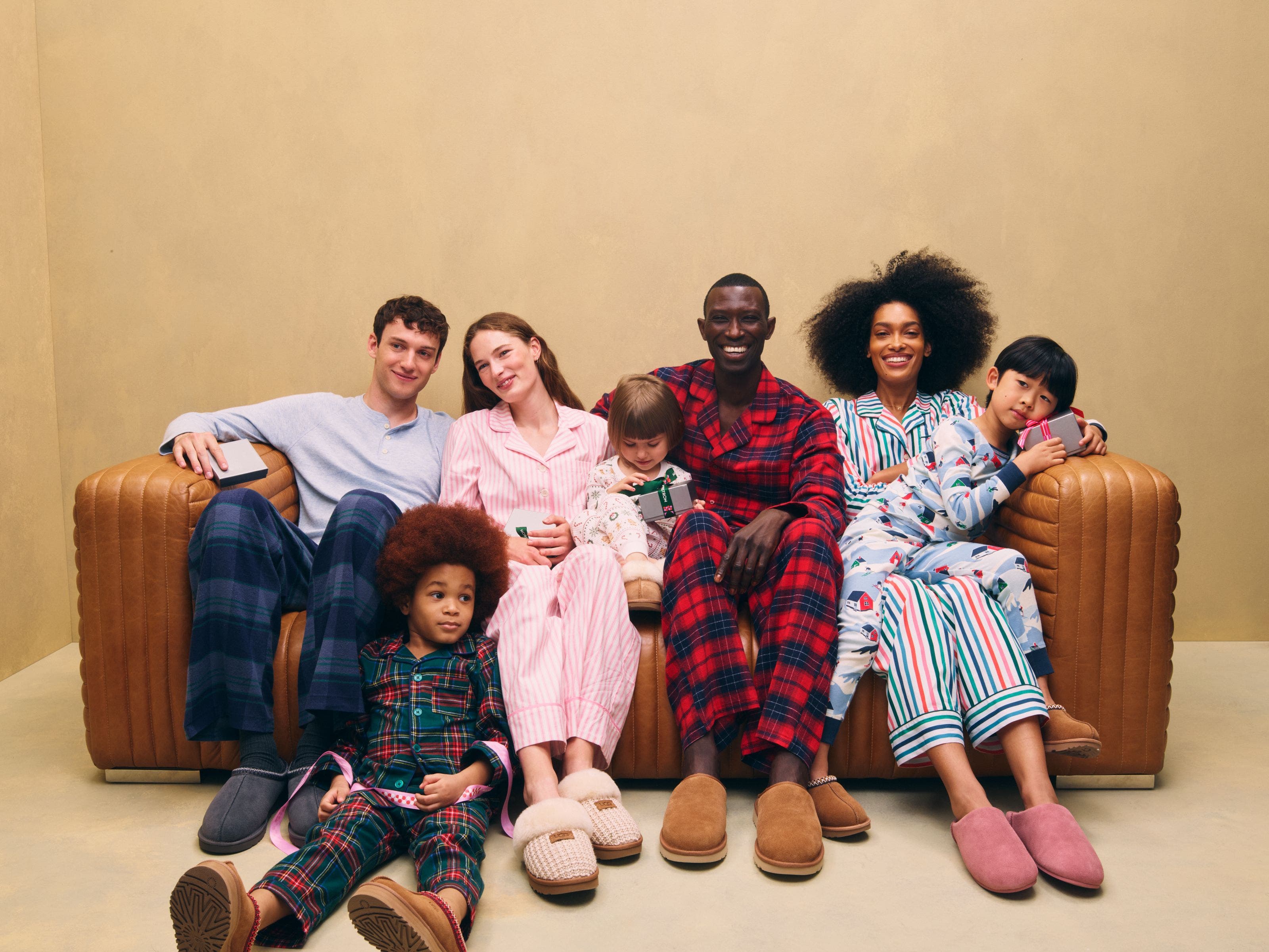 Men, women and kids wearing UGG slippers and family PJs.