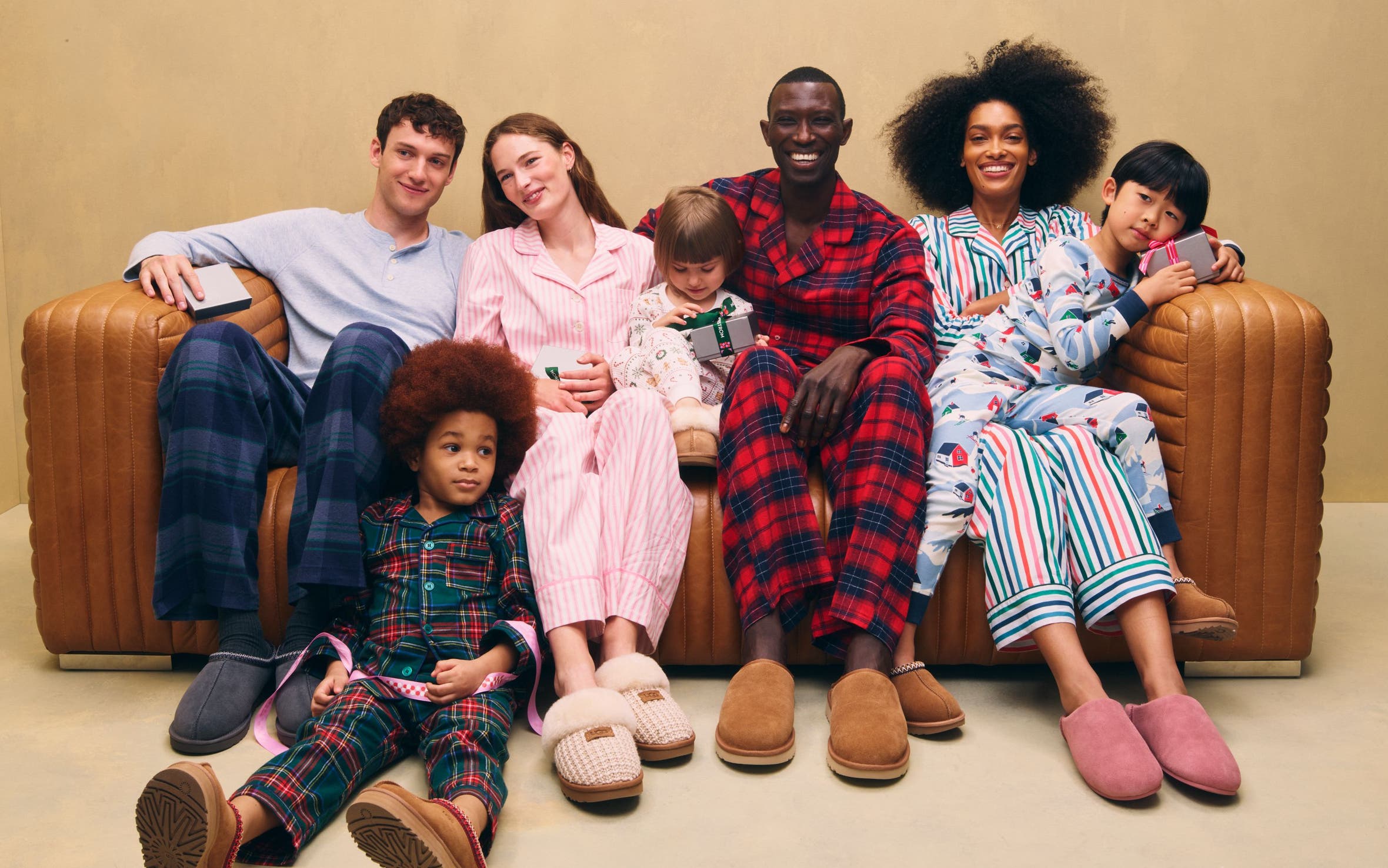 Men, women and kids wearing UGG slippers and family PJs.