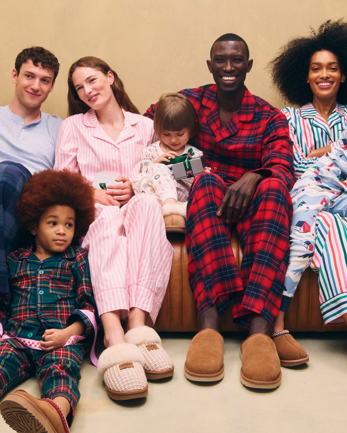 Men, women and kids wearing UGG slippers and family PJs.
