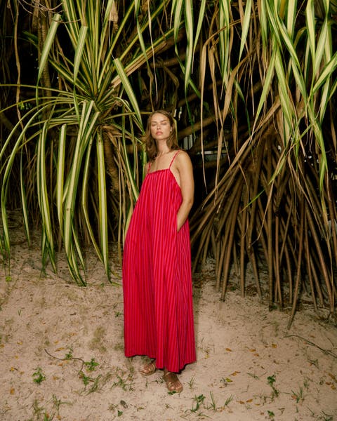 Woman wearing a red maxi dress.