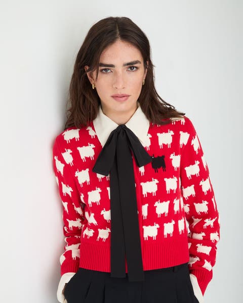 A woman in red sheep-print cardigan.