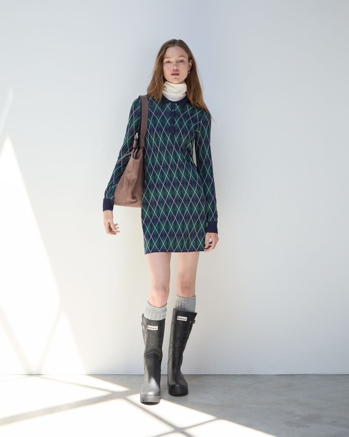 A woman wearing a sweaterdress.