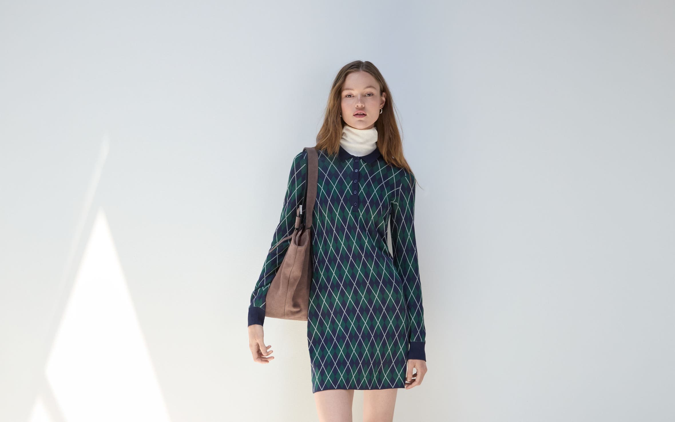 A woman wearing a sweaterdress.