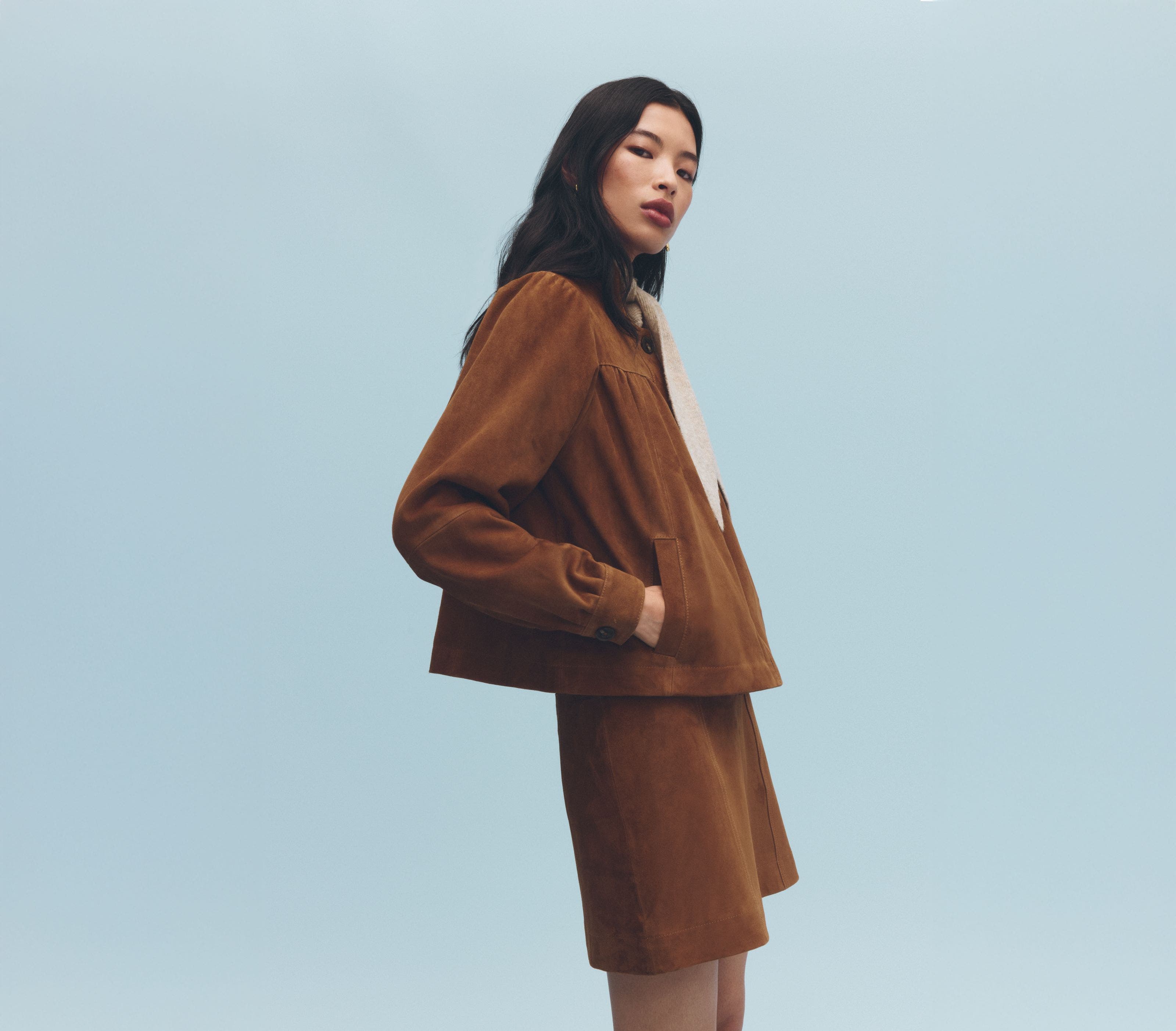 A woman wearing a suede jacket.
