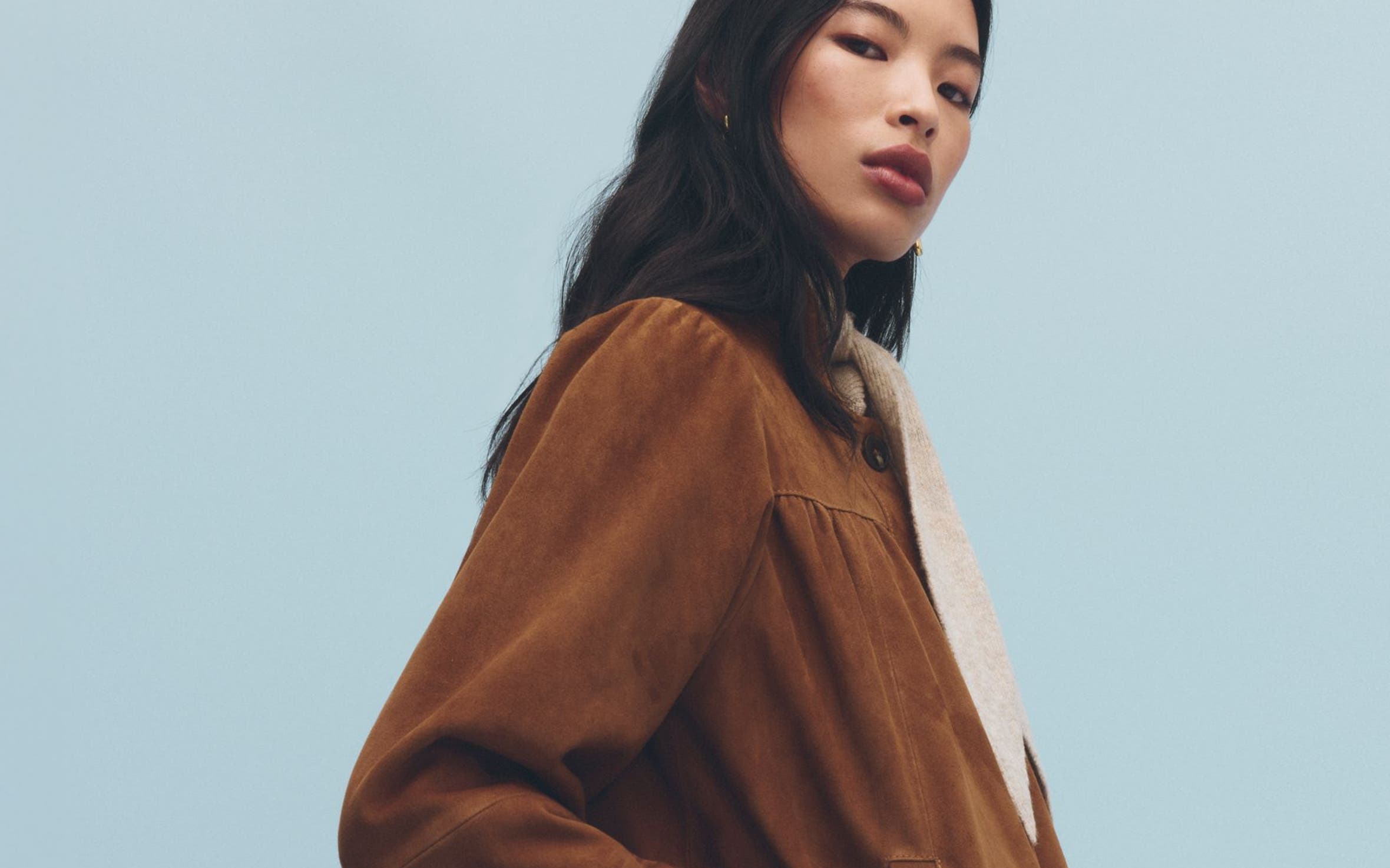 A woman wearing a suede jacket.