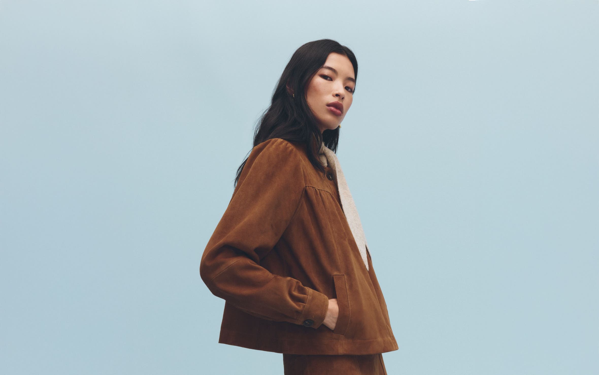 A woman wearing a suede jacket.
