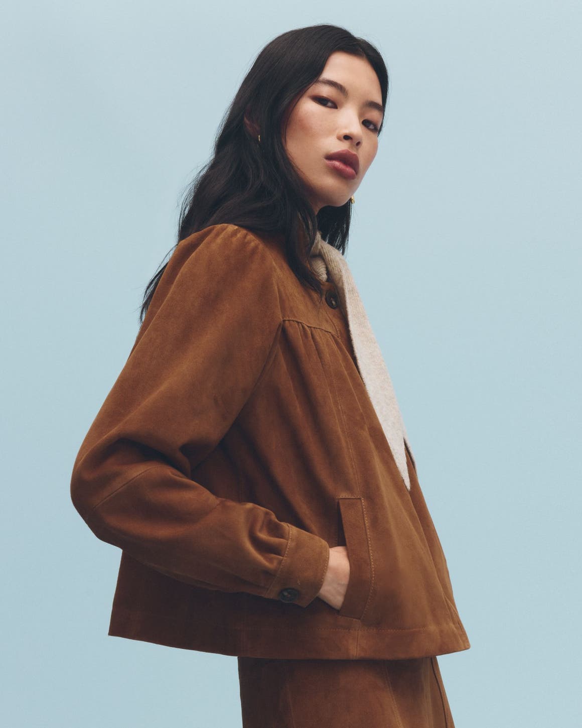 A woman wearing a suede jacket.