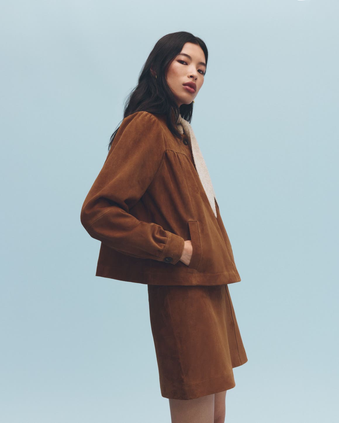 A woman wearing a suede jacket.
