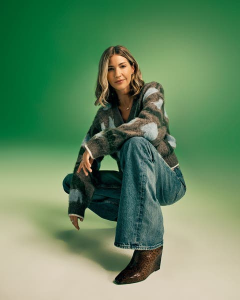 Woman in jeans and a sweater.