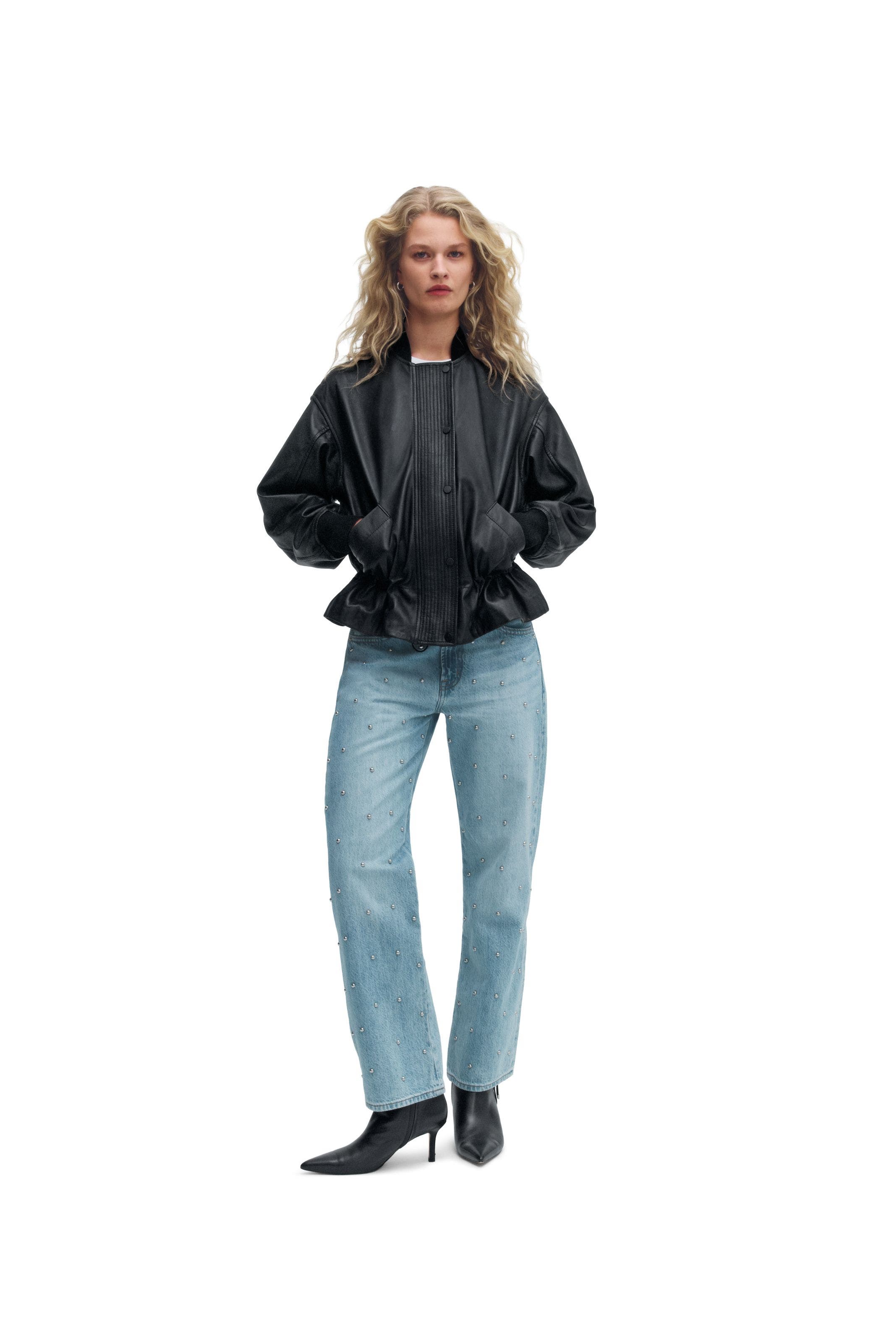 A woman wearing a leather jacket.