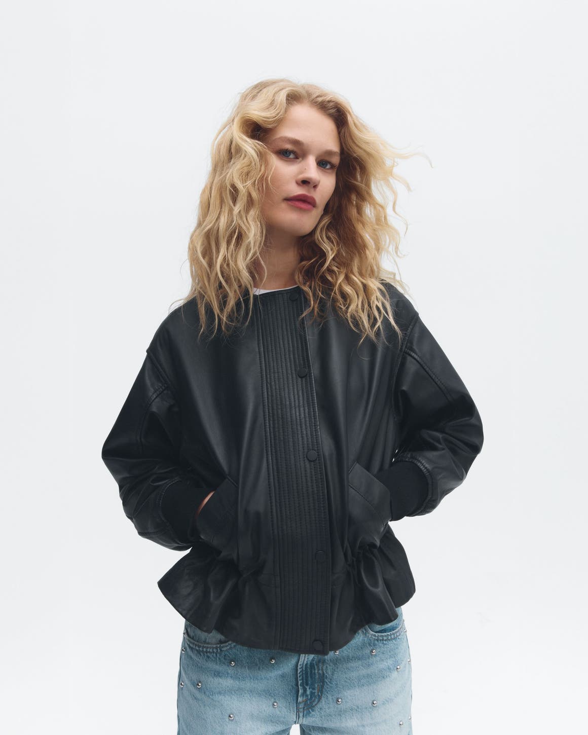 9 to know: a woman wearing a leather jacket.