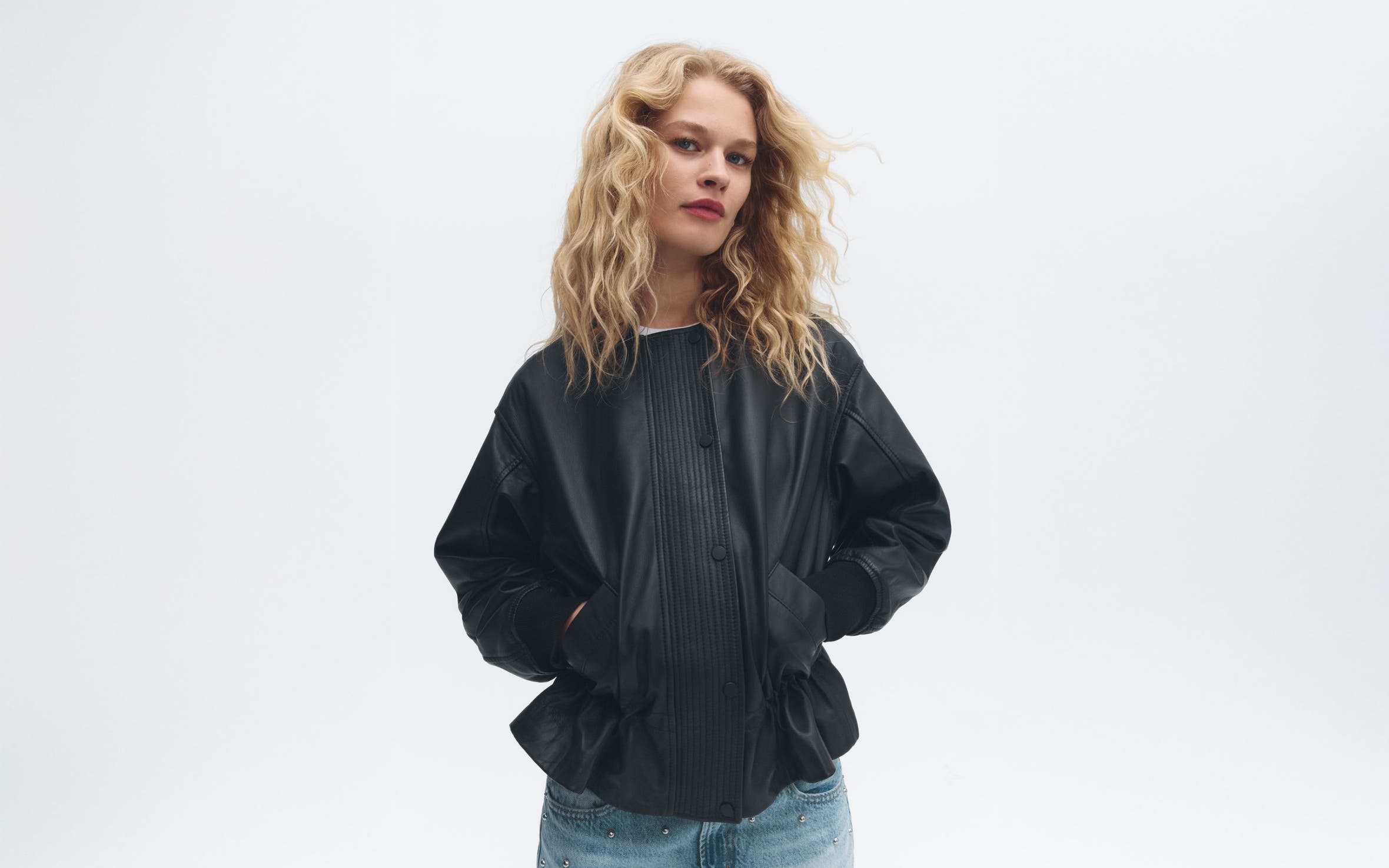 9 to know: a woman wearing a leather jacket.