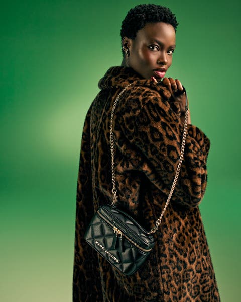 Woman in a leopard-print coat with a black chain-strap bag.
