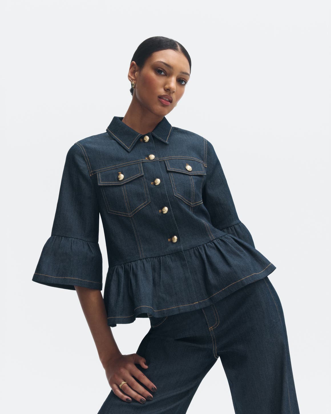 Woman wearing an Anniversary Sale denim top and jeans.