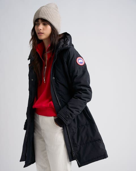 A woman wearing a black Canada Goose parka.