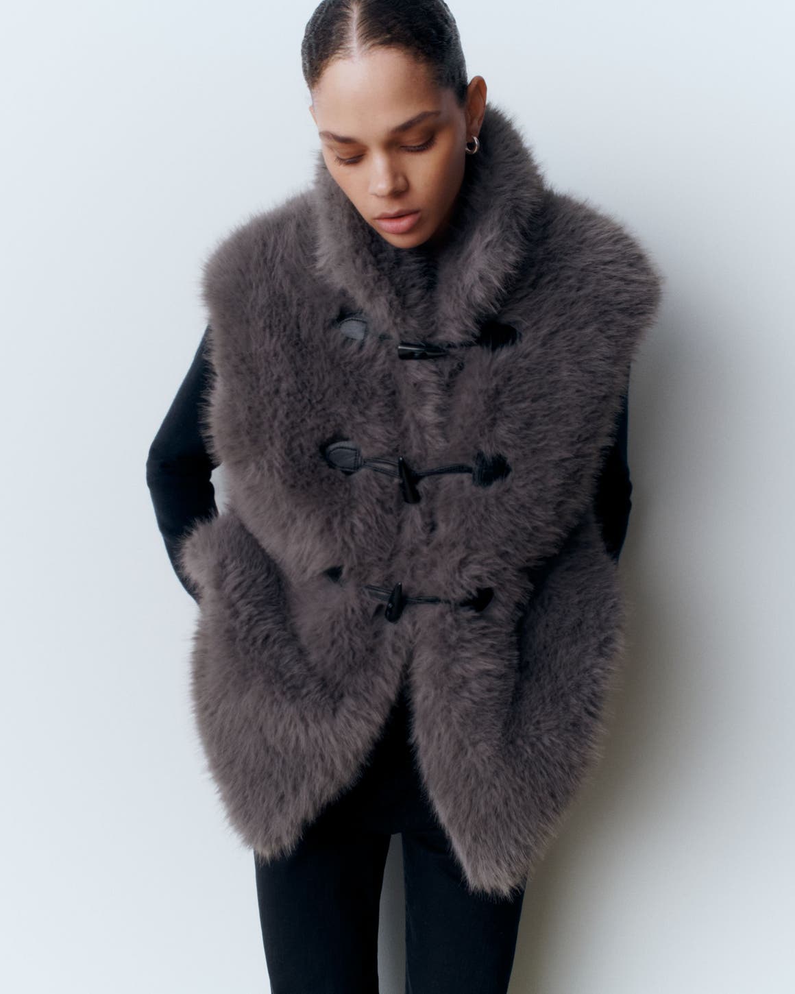 A woman wearing a faux-fur vest.