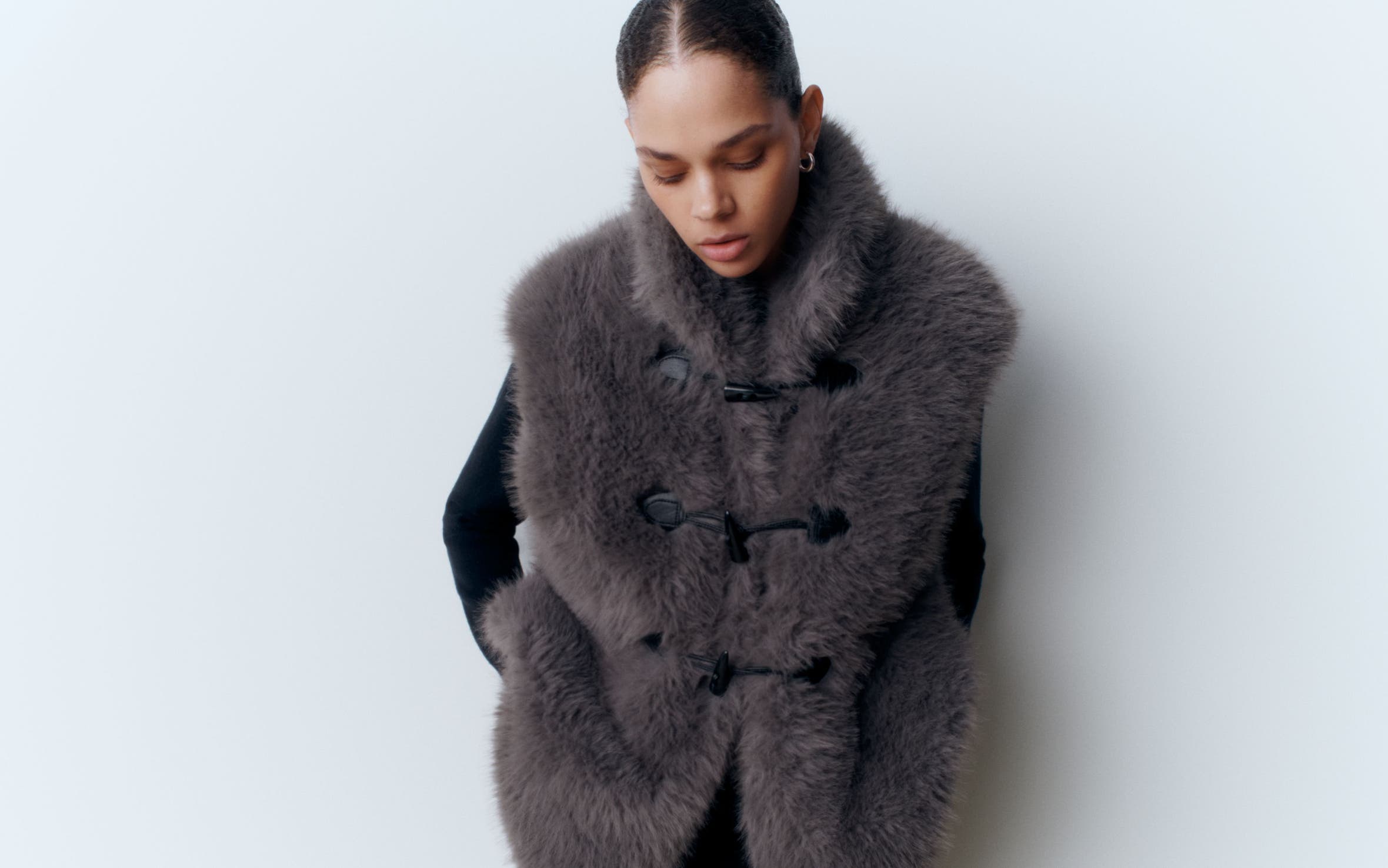 A woman wearing a faux-fur vest.