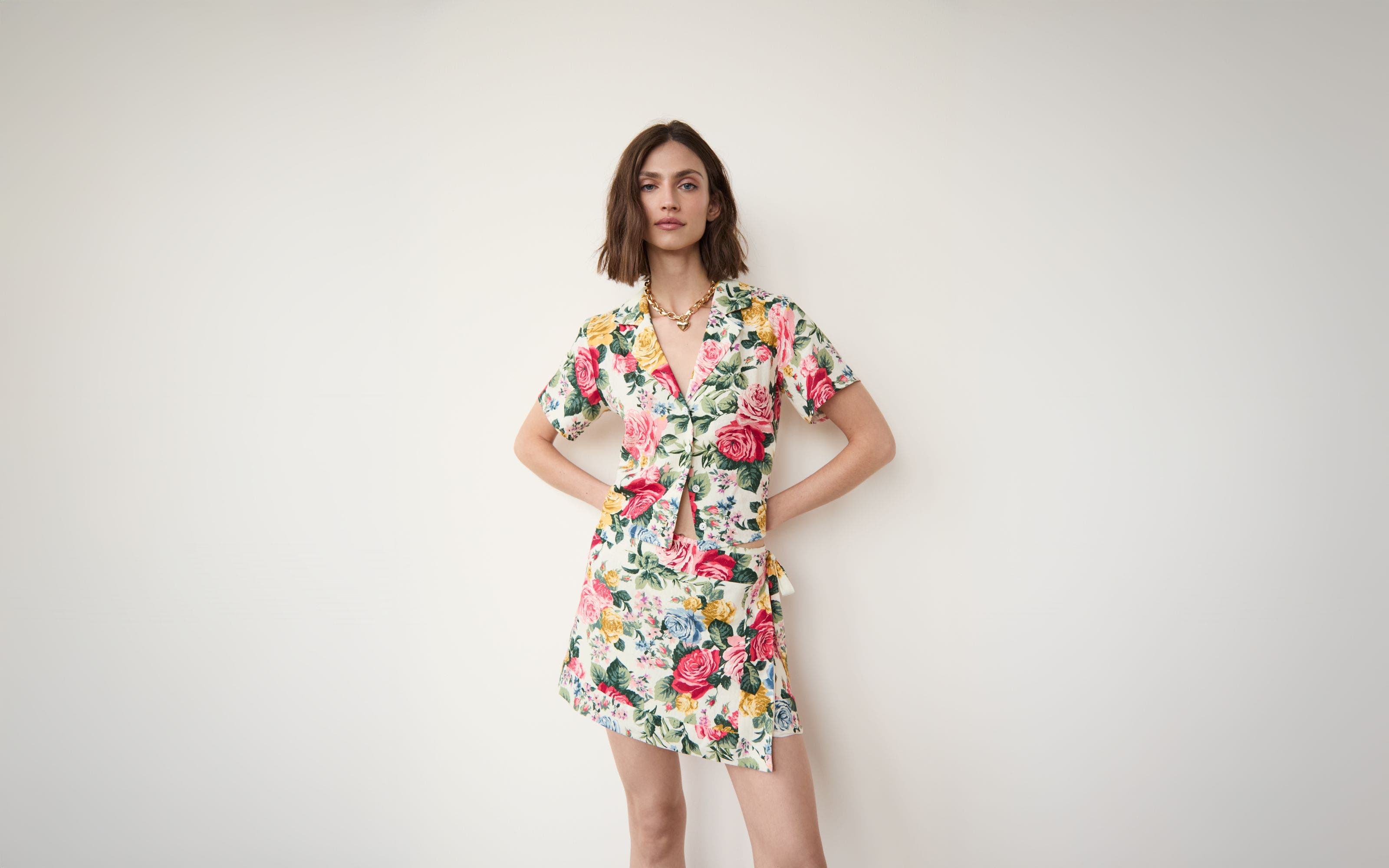 Woman wearing a floral matching set and a necklace.