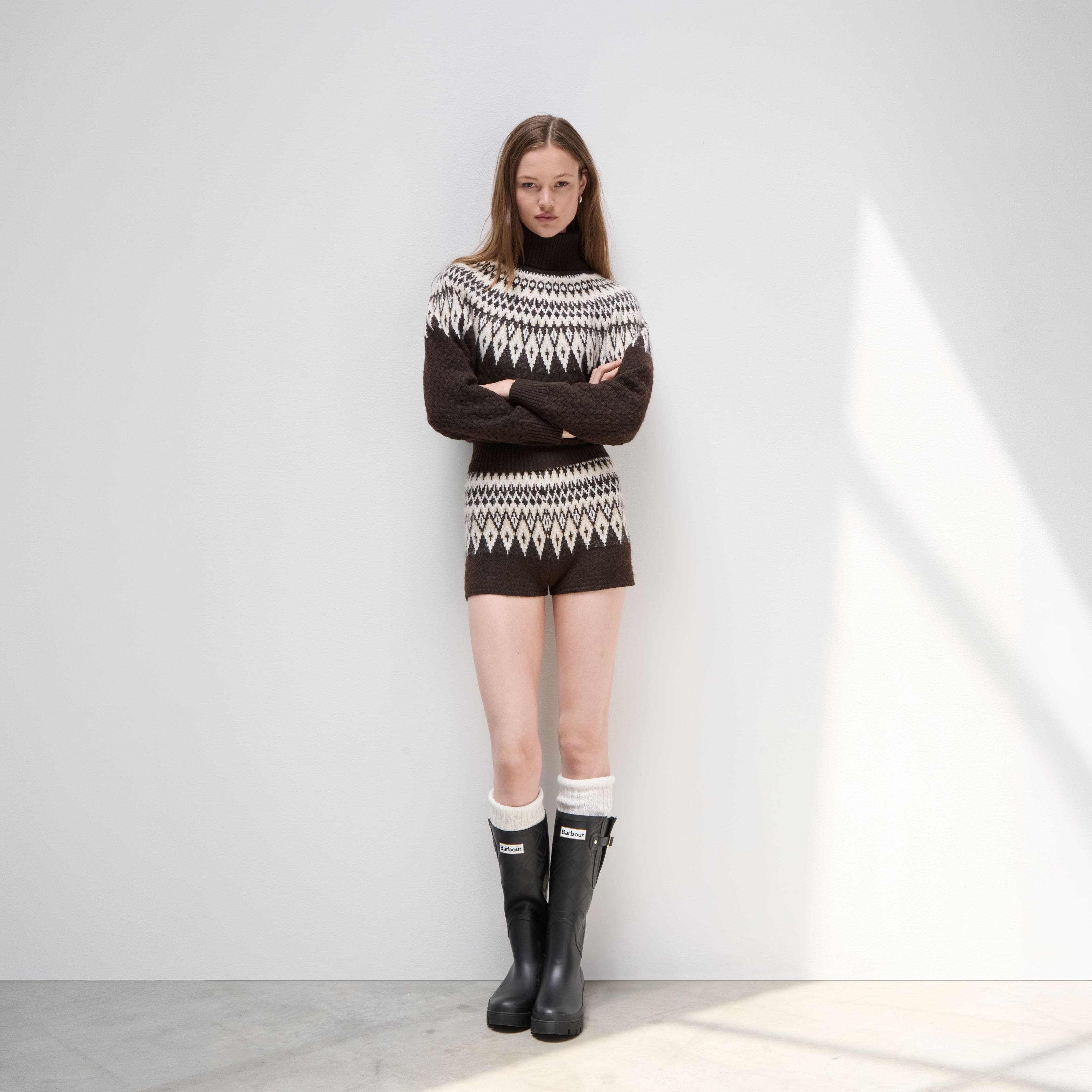 A woman wearing a two-piece knit set.