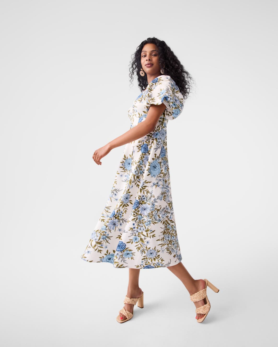 A model wearing a printed dress. 