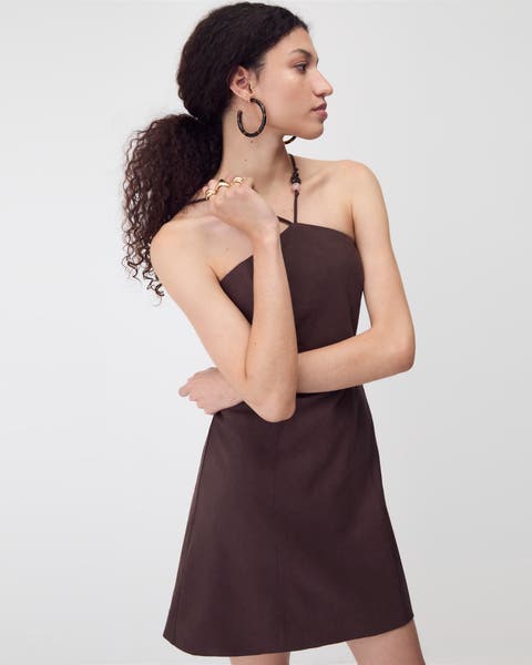 Woman wearing brown halter dress.