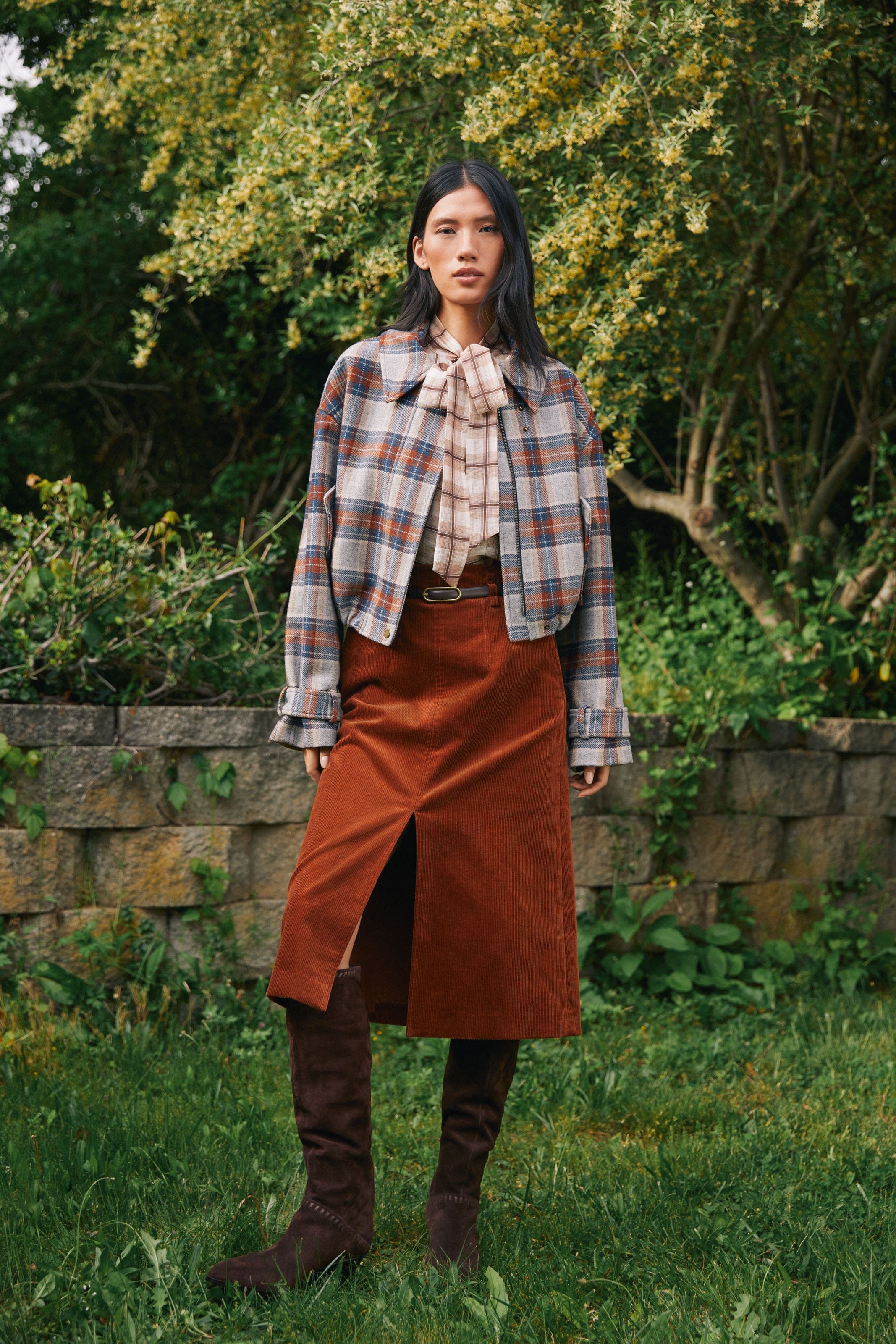 A woman in a plaid jacket.