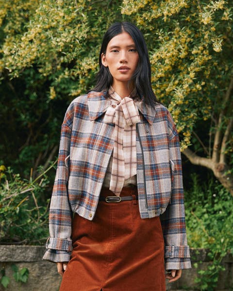 A woman in a plaid jacket.