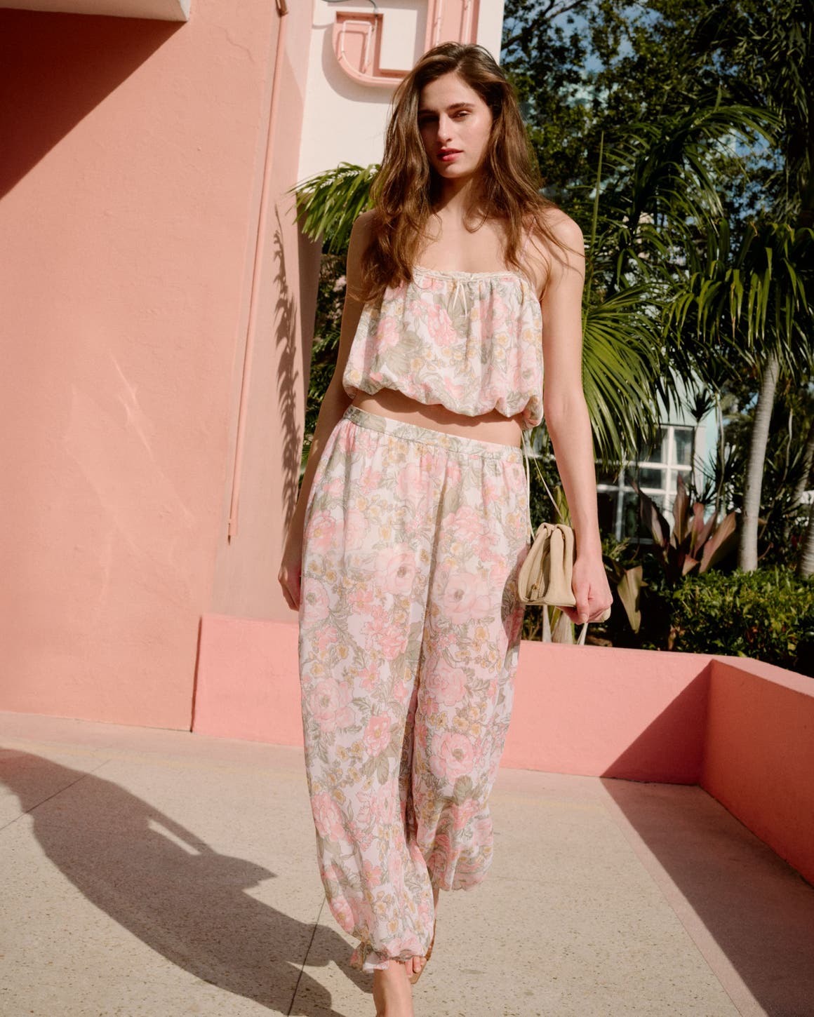 A woman wearing a floral-print top and matching pants.
