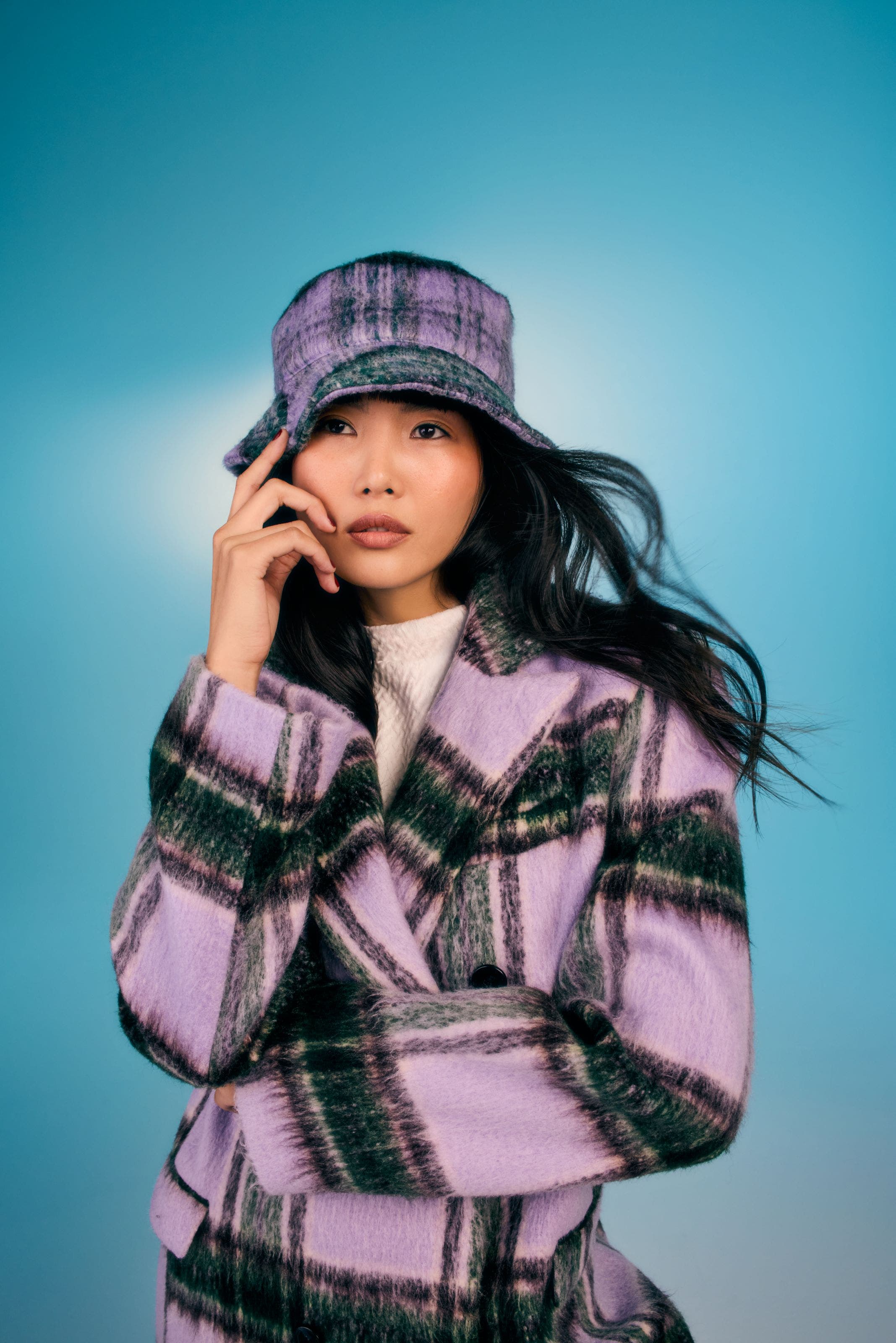 Girl wearing a plaid wool coat.