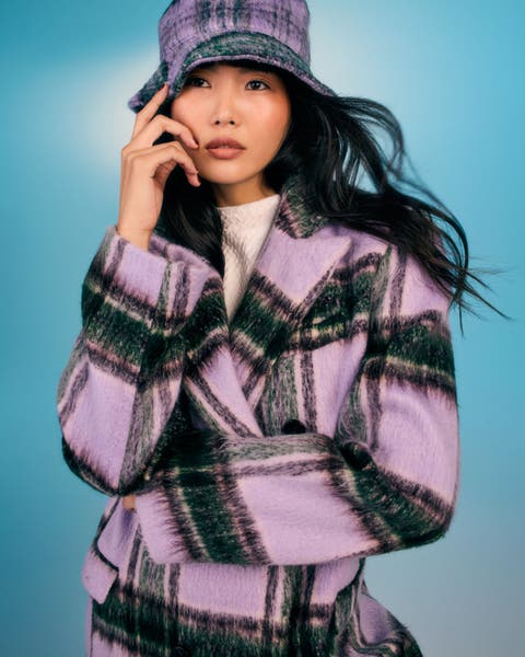 Girl wearing a plaid wool coat.
