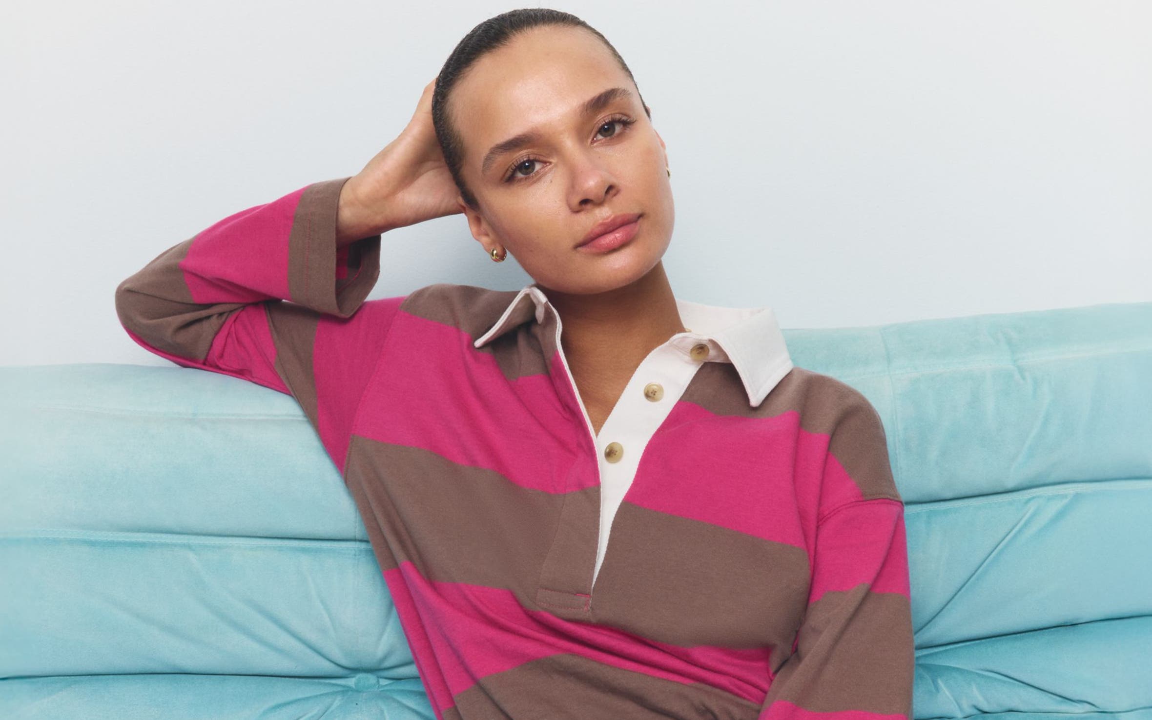 A woman wearing a striped polo shirt.