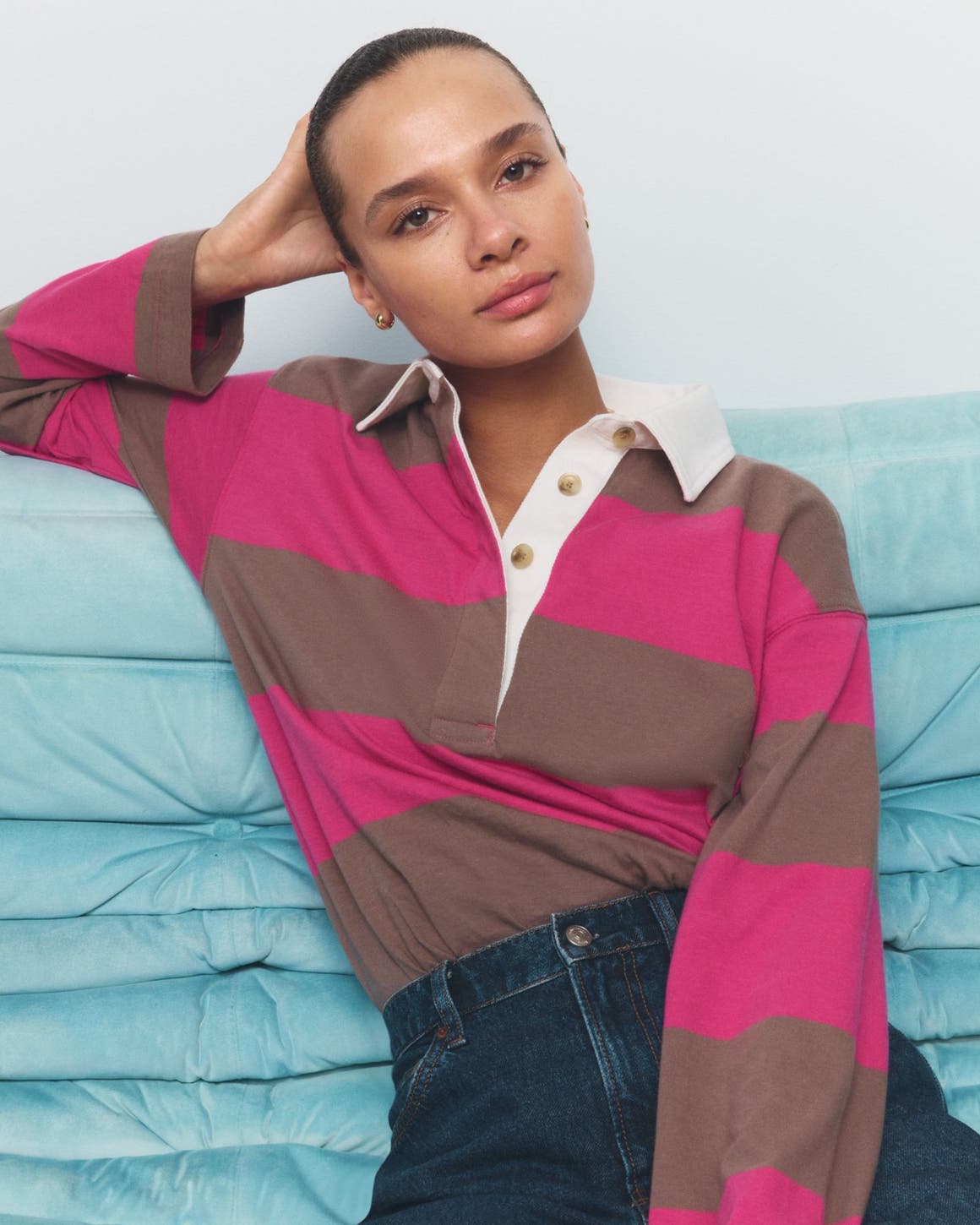 A woman wearing a striped polo shirt.