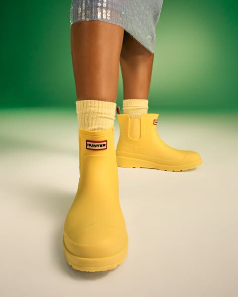 Woman in yellow Hunter boots.