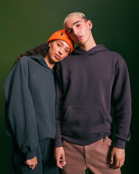 A teenage girl and boy wearing hoodies.