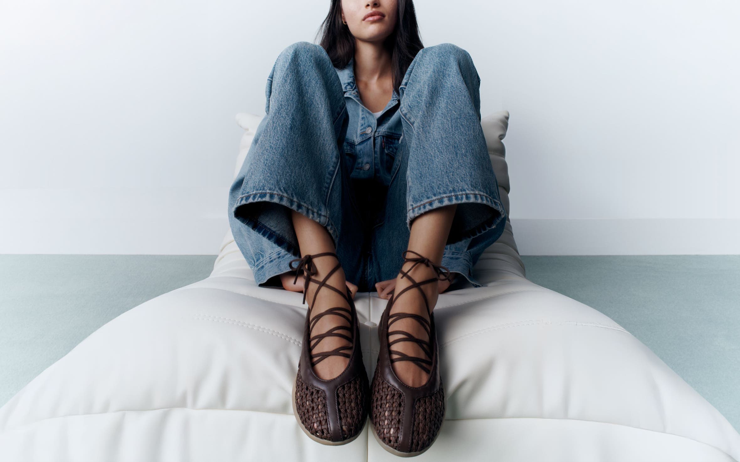 A woman wearing lace-up sneakers.