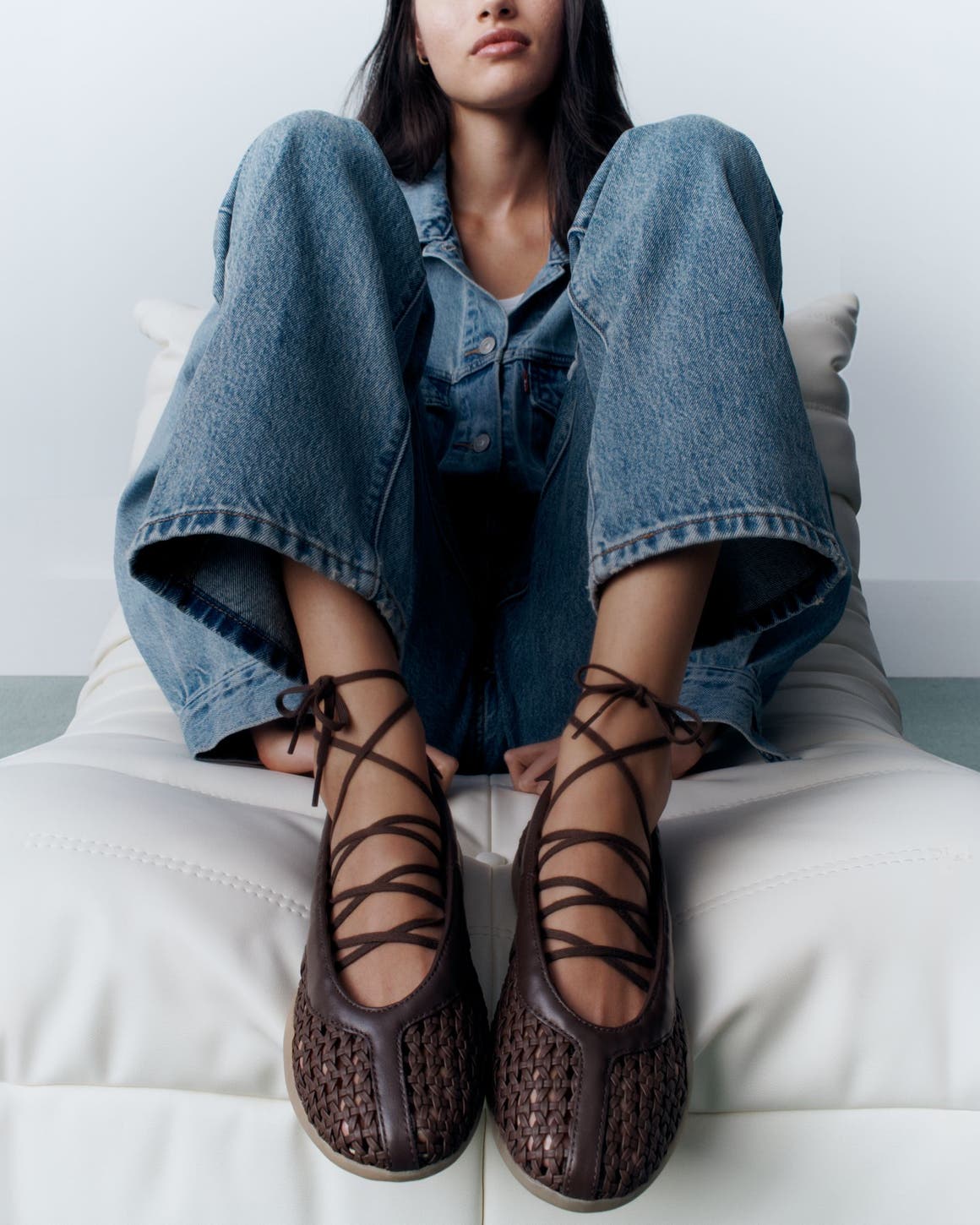 A woman wearing lace-up sneakers.