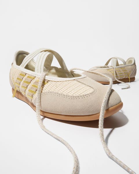 A pair of ballerina-style sneakers.